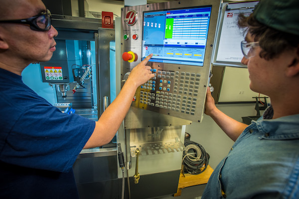 two students at CNC machine