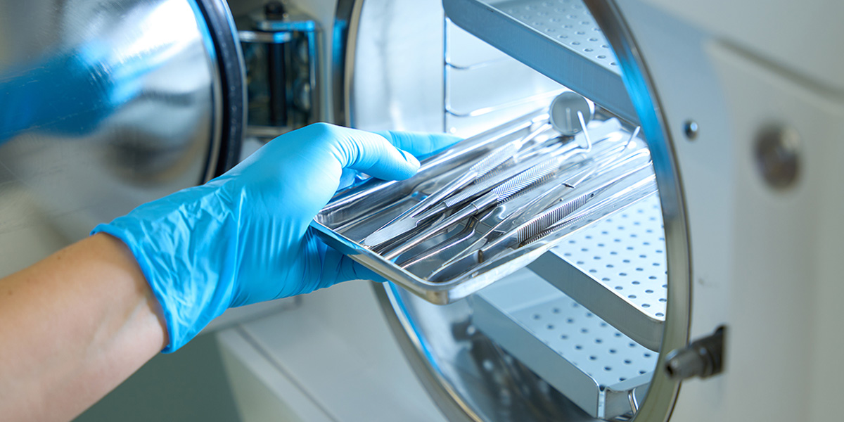 hand holding medical tools on tray