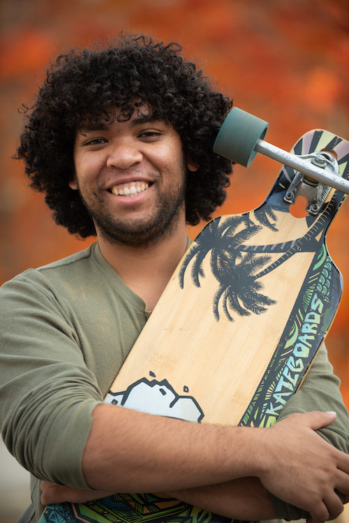 smiling young man with skateboard
